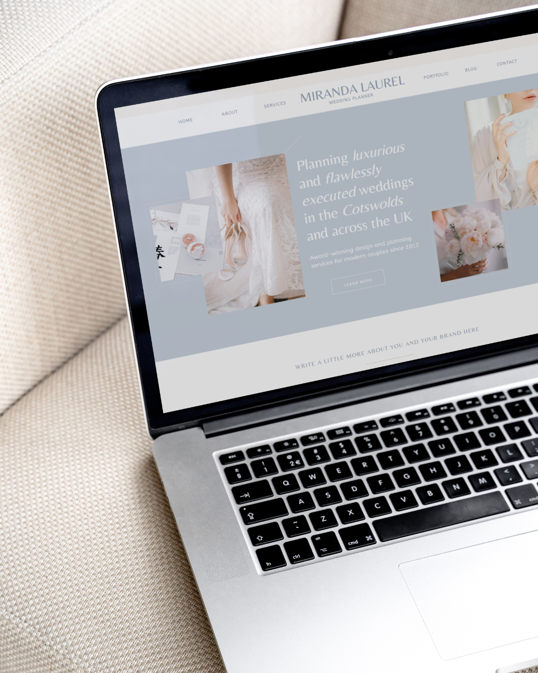 A laptop on a cream sofa with a website template for wedding planners on the screen