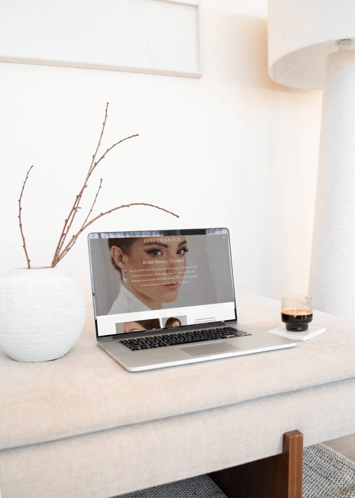 Mockup of a laptop on a bench, showcasing a bridal hair & makeup artist website on the screen.